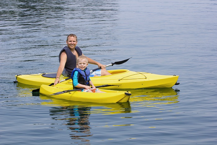 Family Kayaking together on a beautiful lake